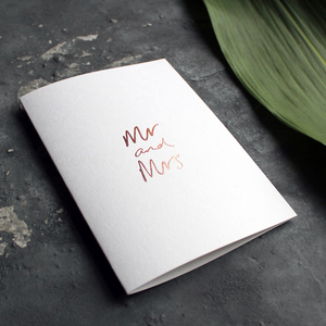 this luxury wedding card that's handwritten with a rose gold foil message saying mr and mrs