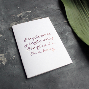 a rose gold foil christmas card says single bells single bells single all the way on the front