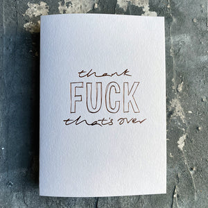This luxury Christmas Card has a hand written rose gold foil block message saying Thank Fuck That's Over on the front